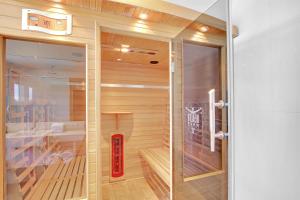 a sauna with a wooden floor and a glass door at 5 Knots Metung in Metung