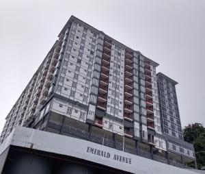 a tall apartment building with the words emerald avenue at FuYoke Emerald Avenue @ Brinchang in Cameron Highlands