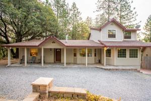 a house with a gravel driveway in front of it at Mountain Retreat with Hot Tub & Pool Table - 1 hour from Squaw Valley Resort! in Colfax