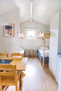 a room with two bunk beds and a table at Vännäs bad & camping in Vännäs