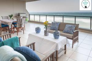 a living room with a view of the ocean at Coral Reef in La Mercy