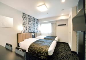 Krevet ili kreveti u jedinici u objektu APA Hotel Nagoya Ekimae Minami