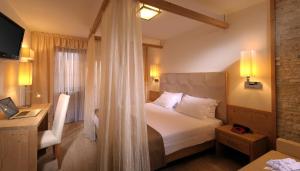 Postel nebo postele na pokoji v ubytování Hotel La Perla