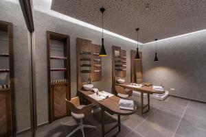 a wine tasting room with two tables and chairs at Faros Hotel Ayia Napa in Ayia Napa