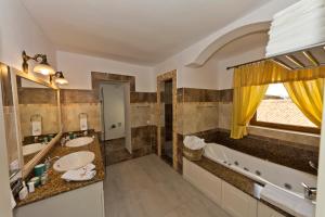 a large bathroom with two sinks and a tub at ApartamentS in Râşnov +73 photos