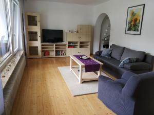 uma sala de estar com um sofá e uma mesa em Ferienwohnung Betz em Riedenburg