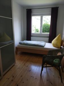 um pequeno quarto com uma cama e uma janela em Ferienwohnung Betz em Riedenburg