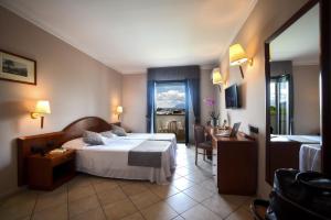 Postel nebo postele na pokoji v ubytování Hotel Le Palme