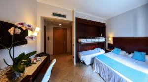 Postel nebo postele na pokoji v ubytování Hotel Le Palme