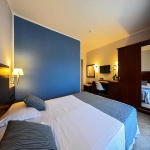 Postel nebo postele na pokoji v ubytování Hotel Le Palme