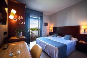 Postel nebo postele na pokoji v ubytování Hotel Le Palme