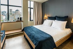 a hotel room with a bed and a window at Ciel Living Athens in Athens +97 photos
