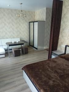 a room with a bed and a table and a mirror at МилЭлин in Krasnodar