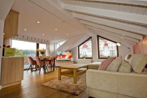 a living room with a couch and a table at ApartamentS in Râşnov