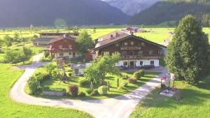 an aerial view of a house in a green field at Mussbachhof in Saalfelden am Steinernen Meer