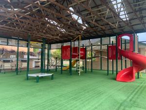 a playground with a red slide and a slideintend at Studio32 in Albany