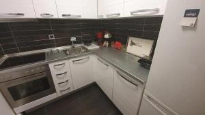 a small kitchen with a sink and a stove at City Center Comfortable Studio Apartment in Kavála
