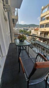 a balcony with a table and chairs on a building at City Center Comfortable Studio Apartment in Kavála