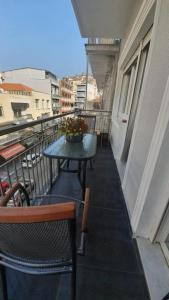 - Balcón con mesa y sillas en un edificio en City Center Comfortable Studio Apartment, en Kavala