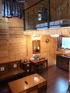 a room with wooden walls and a table and a sink at 薔薇谷 民宿字108號 in Fuxing