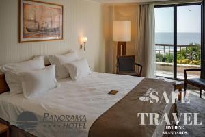 a hotel room with a bed with a view of the ocean at Panorama Hotel - Free EV Charging Station in Varna City