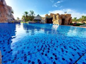 a pool at a resort with blue water at Danat Al Ain Resort in Al Ain