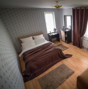 a bedroom with a large bed in a room at PaulMarie Apartments on Zaslonova 74 in Soligorsk