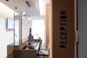 
a kitchen with a sink and a refrigerator at The Central City - Luxury ApartHotel in Luxembourg
