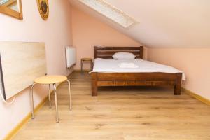 a small bedroom with a bed and a chair at Economy Express Voyage Lviv in Lviv