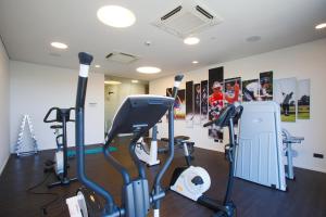 a gym with treadmills and ellipticals in a room at enso Hotel in Ingolstadt