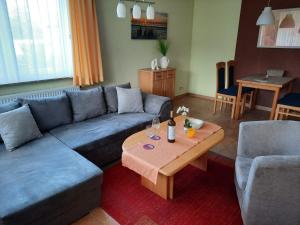 a living room with a couch and a coffee table at Ferienwohnung Cubanzeneck in Kühlungsborn