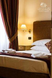 Ένα ή περισσότερα κρεβάτια σε δωμάτιο στο giardini del Novecento