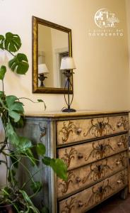 a mirror on top of a dresser with a lamp at giardini del Novecento in Lamezia Terme