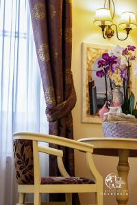 a table with a chair and a table with a vase of flowers at giardini del Novecento in Lamezia Terme