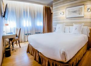 Cama o camas de una habitación en Hotel Opera