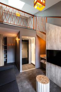 a living room with a staircase and a table at Hotel Base Camp Lodge - Bourg Saint Maurice in Bourg-Saint-Maurice