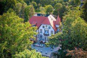 an overhead view of a large house with a red roof at Hotel Villam in Bielawa