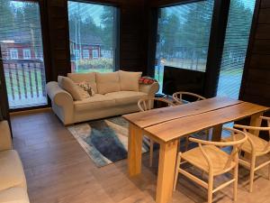 a living room with a couch and a table and chairs at Levi Diamonds in Kittilä