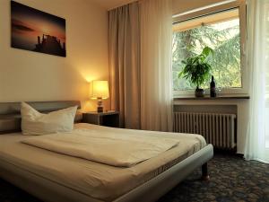 Postel nebo postele na pokoji v ubytování Apart Hotel Freiburg