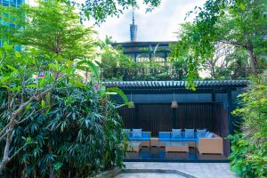 a patio with blue chairs and trees at Ascott IFC Guangzhou - Free Shuttle Bus For Canton Fair in Guangzhou