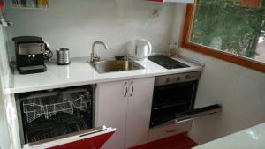a small kitchen with a sink and a dishwasher at Къща Семково in Semkovo