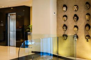 a room with a wall of mirrors and a wall of glass at Paxton Hotel in Port Elizabeth