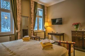 Łóżko lub łóżka w pokoju w obiekcie Hotel BERLINER