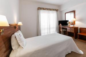 Katil atau katil-katil dalam bilik di Hotel Comendador