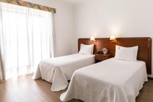 Postel nebo postele na pokoji v ubytování Hotel Comendador