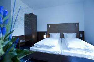 
Ein Bett oder Betten in einem Zimmer der Unterkunft Hotel City Oase Lb
