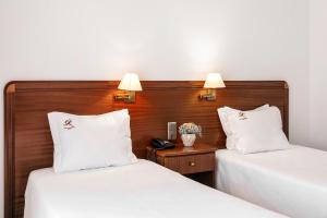 Postel nebo postele na pokoji v ubytování Hotel Comendador