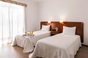 Postel nebo postele na pokoji v ubytování Hotel Comendador