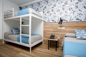 a bedroom with a bed and a desk at Hostal Castilla II Puerta del Sol in Madrid