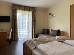 Posteľ alebo postele v izbe v ubytovaní Sástó Hotel
